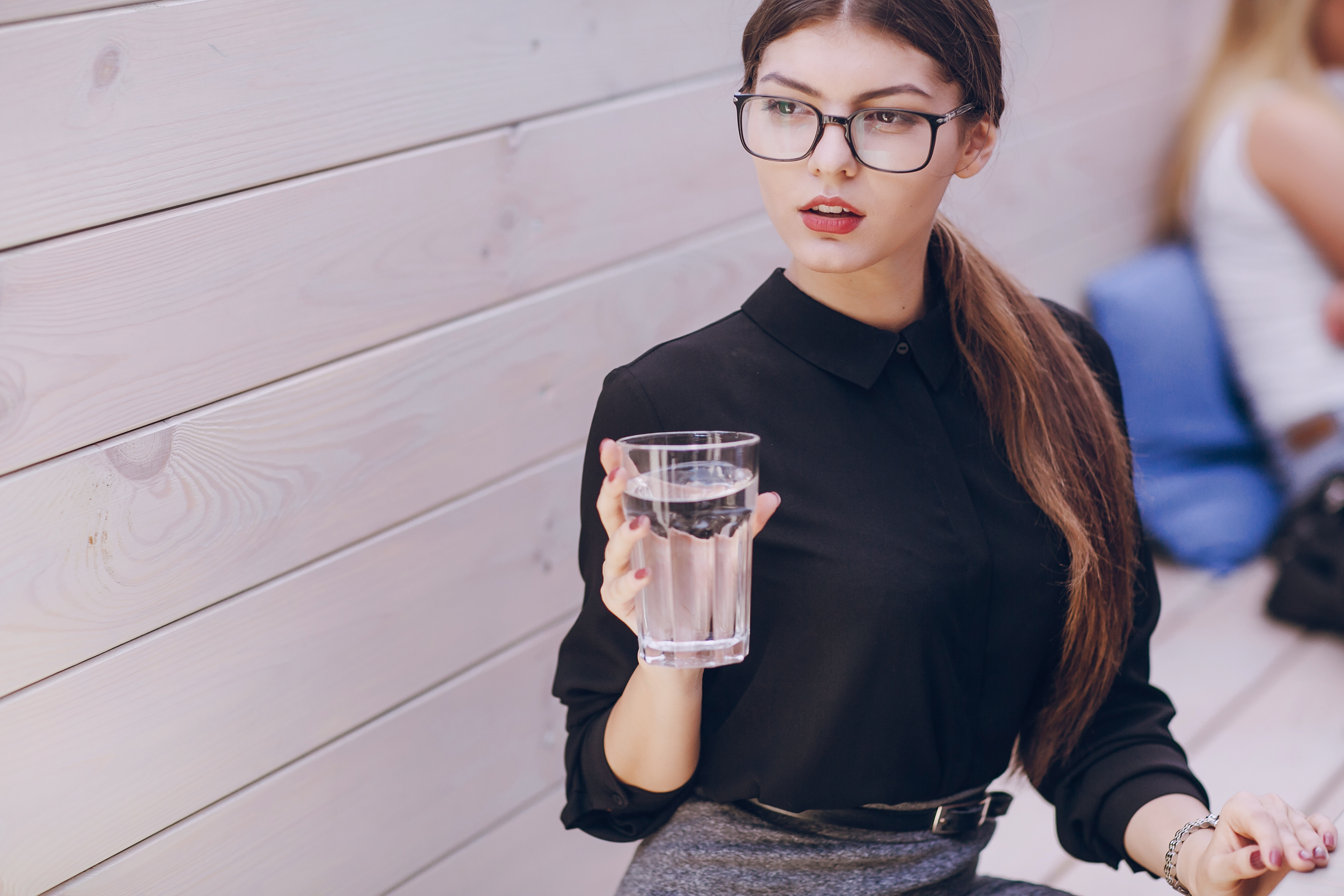 Smiling woman with glass of water